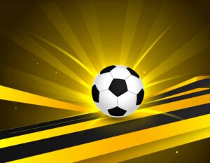 黄色い光が放射状に広がるダイナミックな背景の中央に浮かぶ、白と黒のサッカーボールのイラスト。