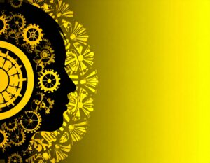 黄色と黒を基調とした、人間の頭部のシルエットと歯車のイラスト。頭の中が大小さまざまな歯車で満たされており、AIや思考の仕組みを象徴している。